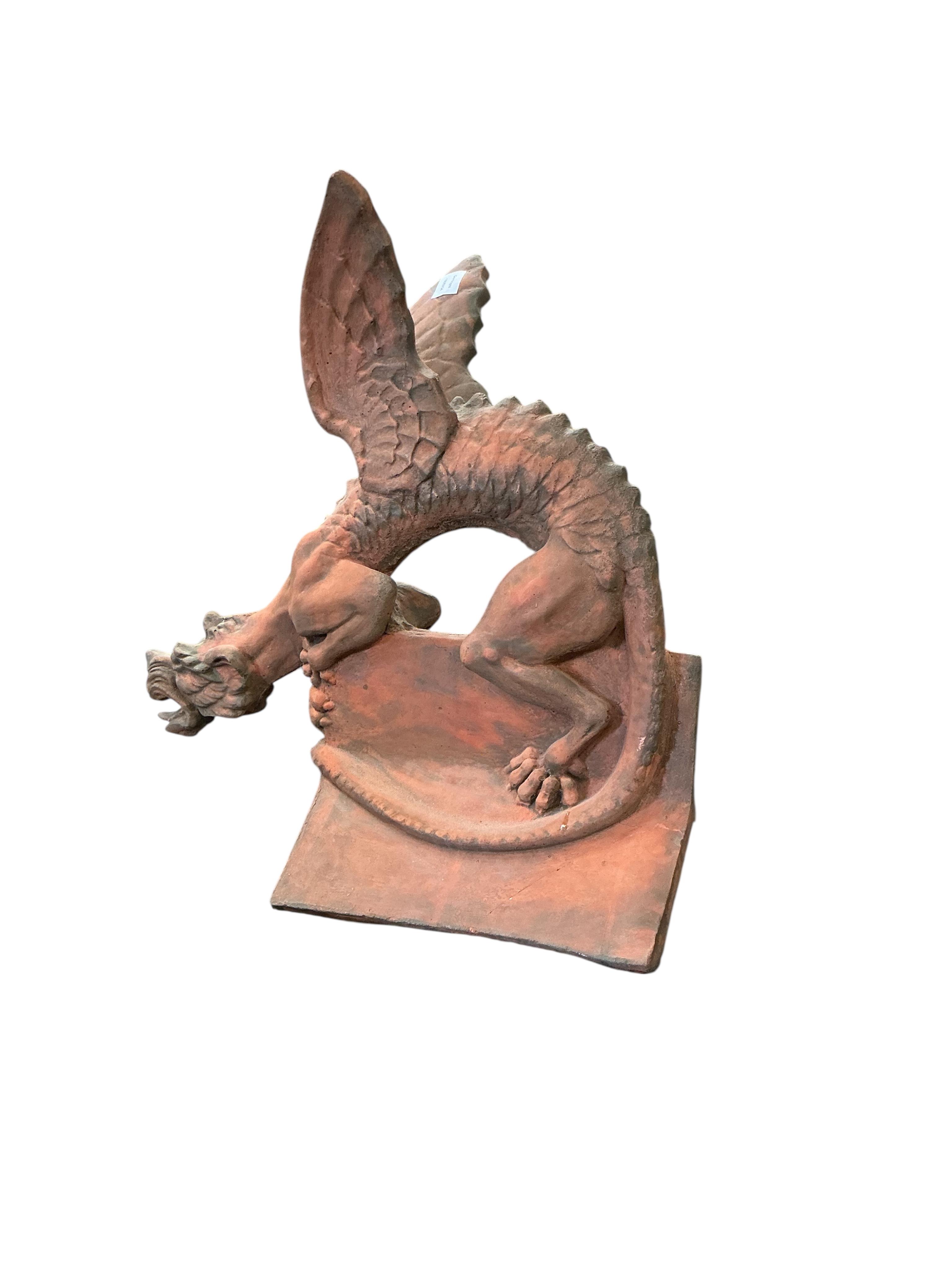 A terracotta gargoyle ridge tile, height 66cm